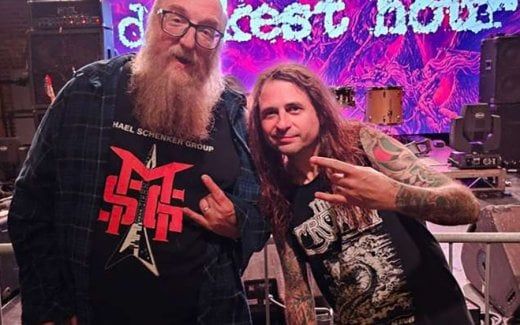 Brian Posehn Photographed With Darkest Hour Holding Mike Schleibaum’s Guitar